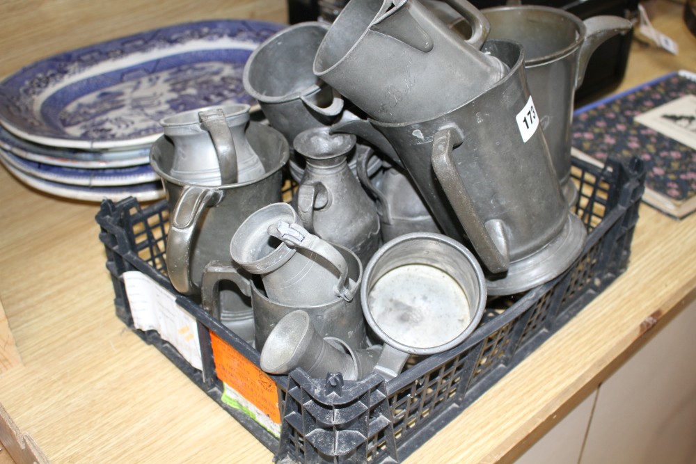 A collection of assorted pewter mugs, measures and dishes